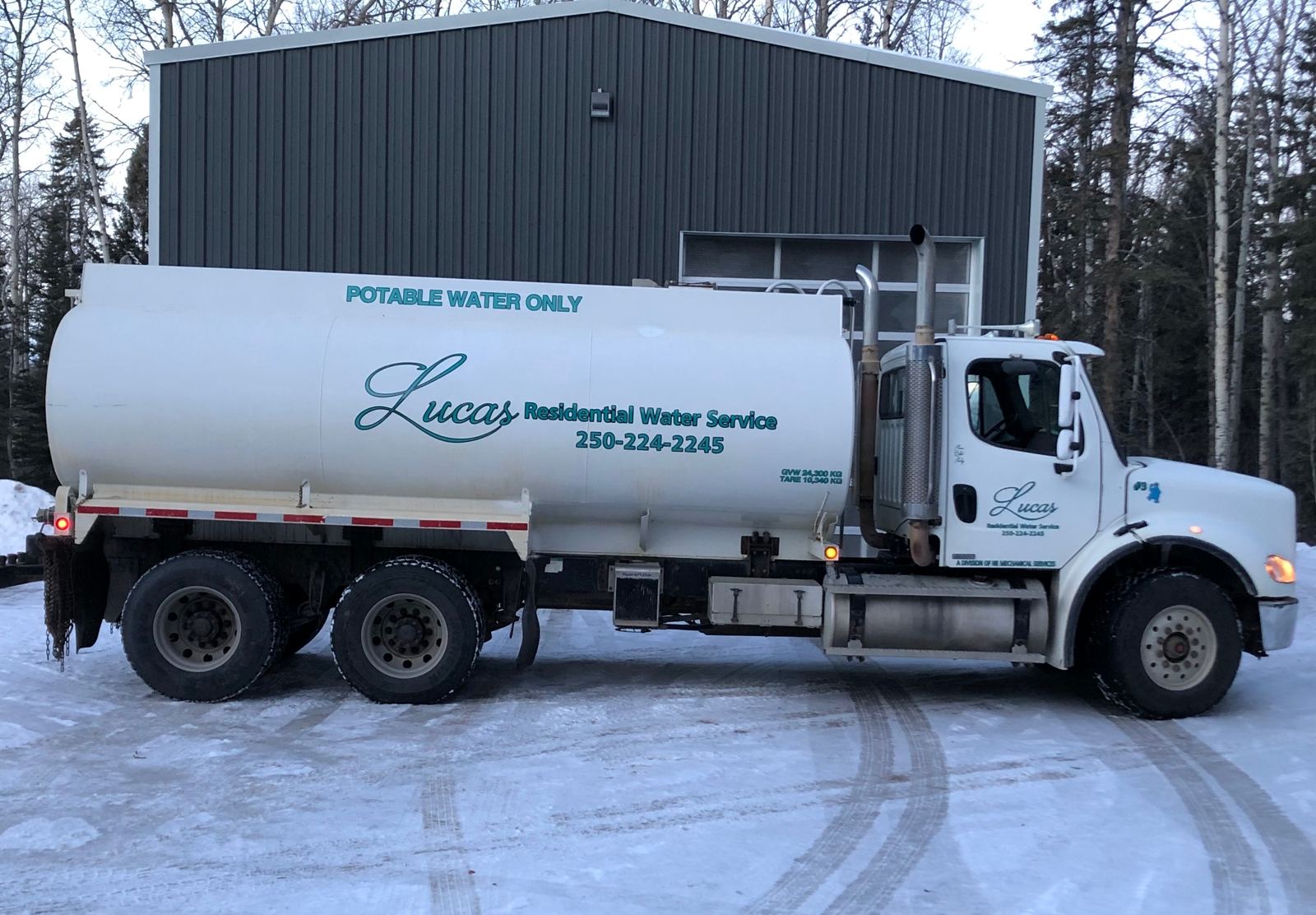 Lucas Water tanker truck marked Potable Water Only parked in front of the shop